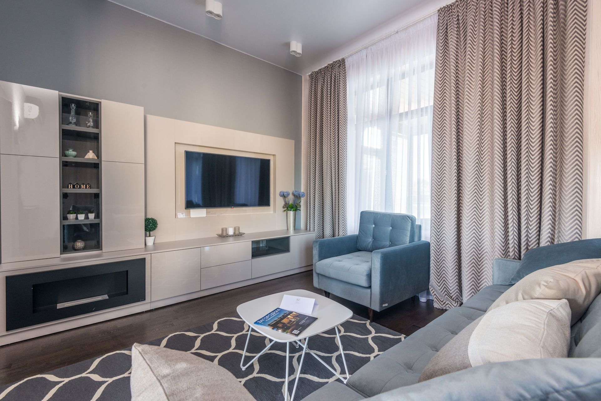 Stylish and modern living room with elegant furniture and decor, creating a cozy atmosphere.